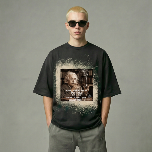 Person wearing a black t-shirt with a graphic design and text, standing against a plain background