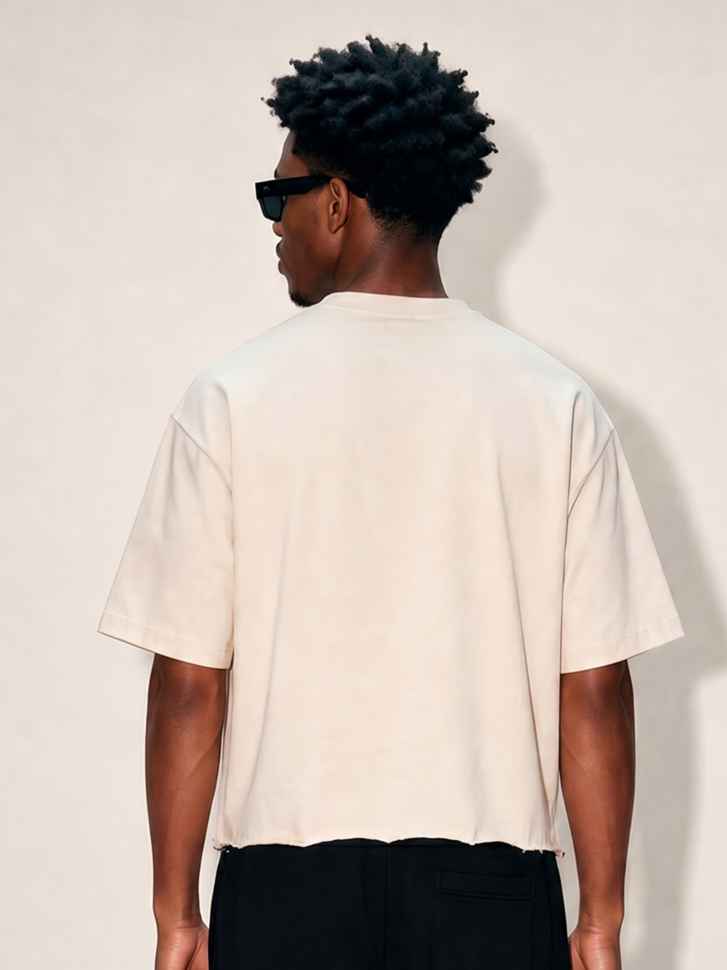 Back shirt of man wearing off-white cropped ultra heavy cotton raw hem t-shirt. 