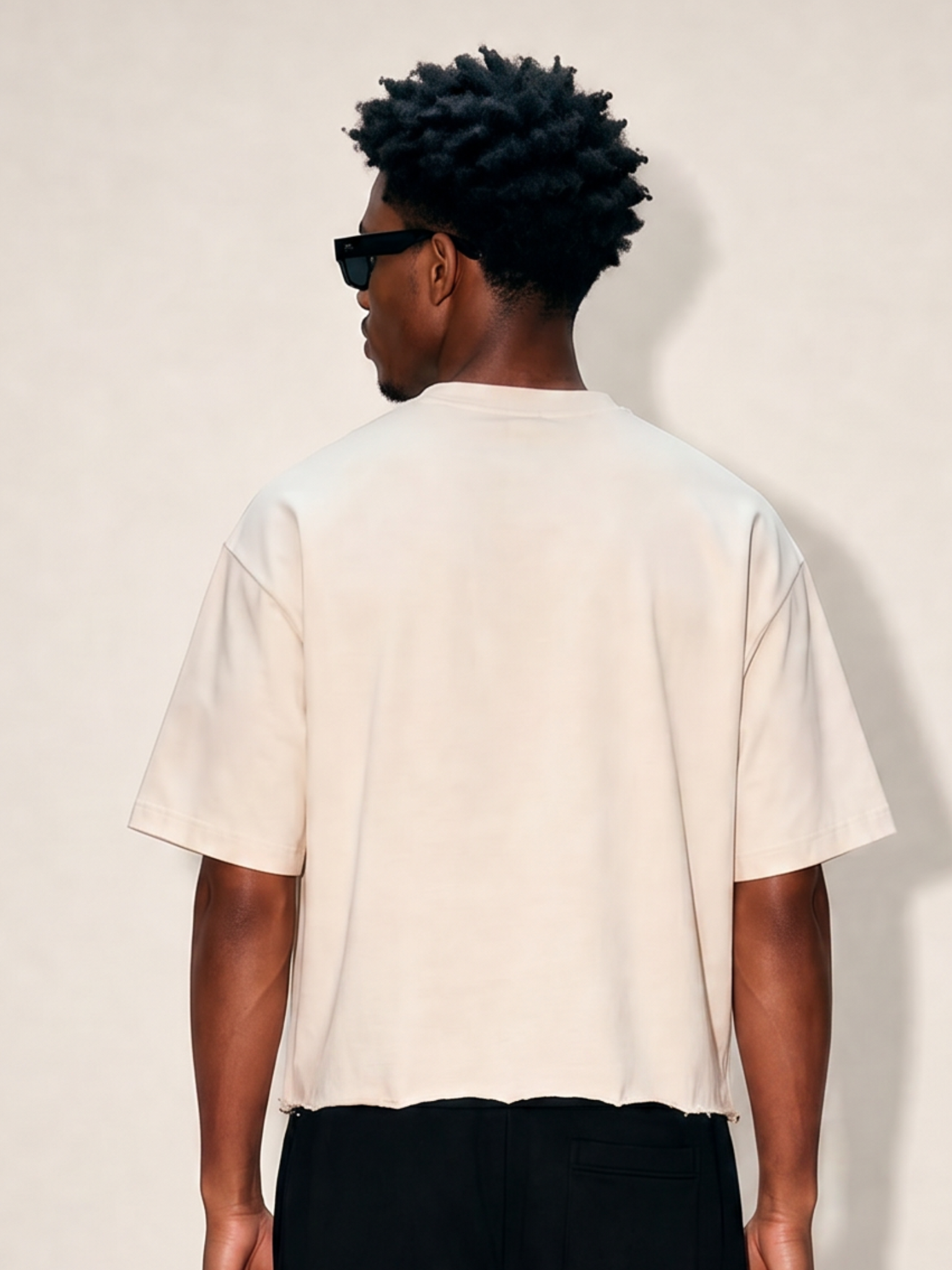 Back shirt of man wearing off-white cropped ultra heavy cotton raw hem t-shirt. 