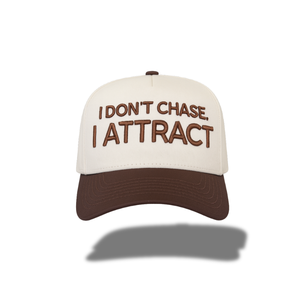 Beige and brown cap with text 'I Don't Chase, I Attract' on a white background