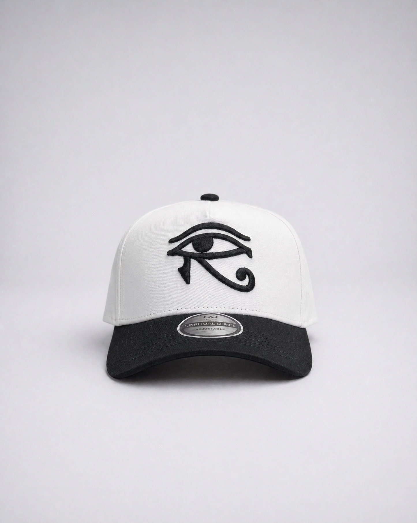 White and black cap with an eye symbol on a light gray background