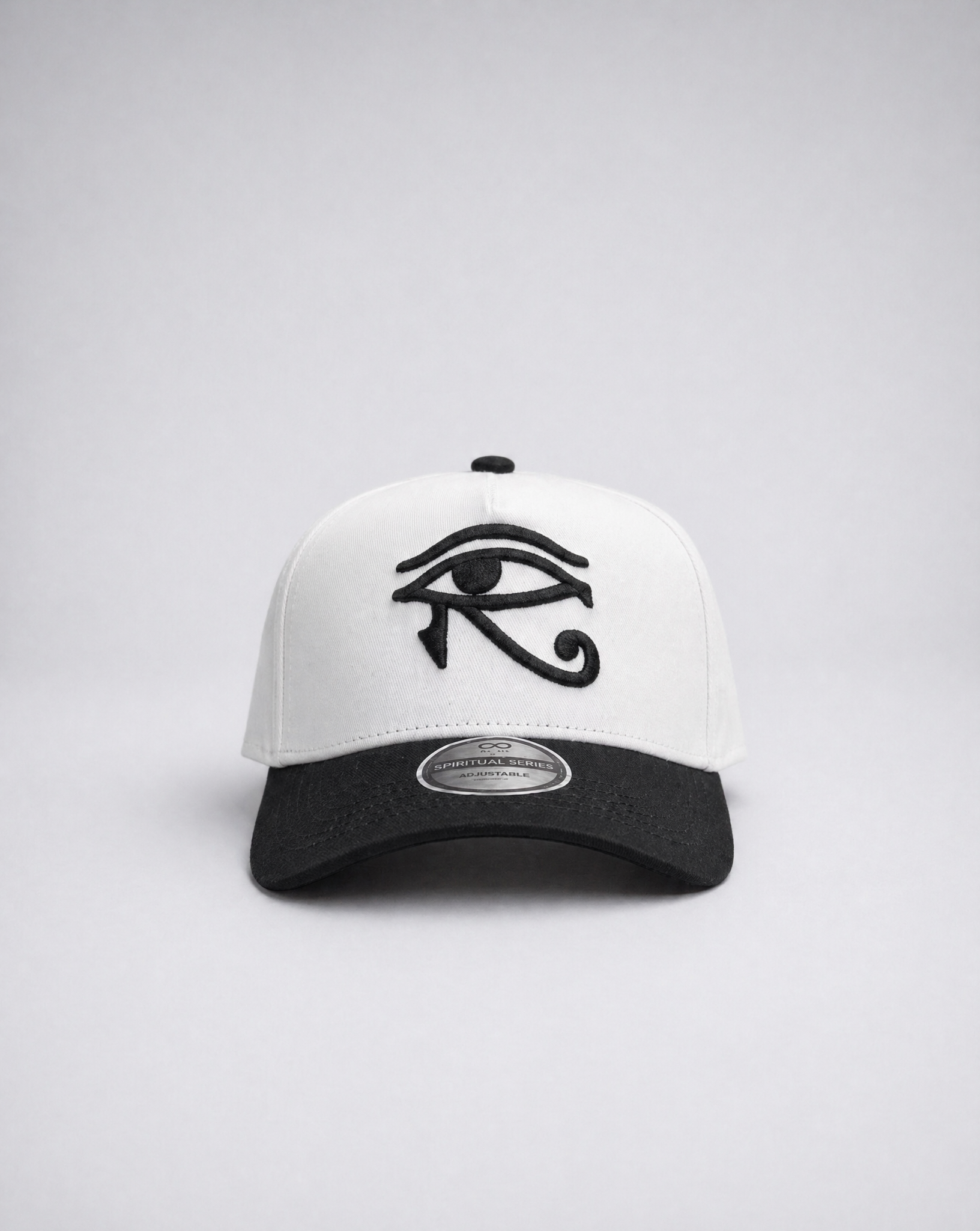 White and black cap with an eye symbol on a light gray background