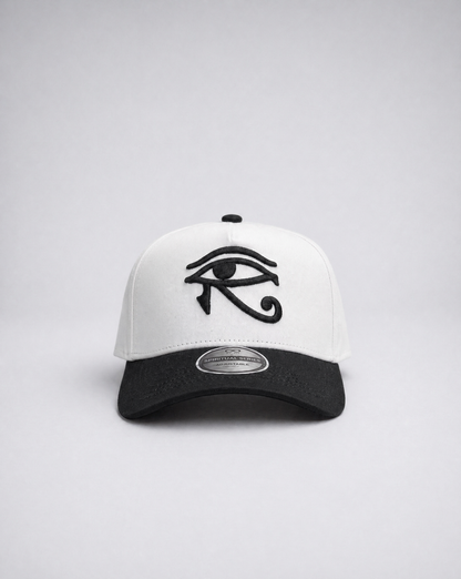 White and black cap with an eye symbol on a light gray background
