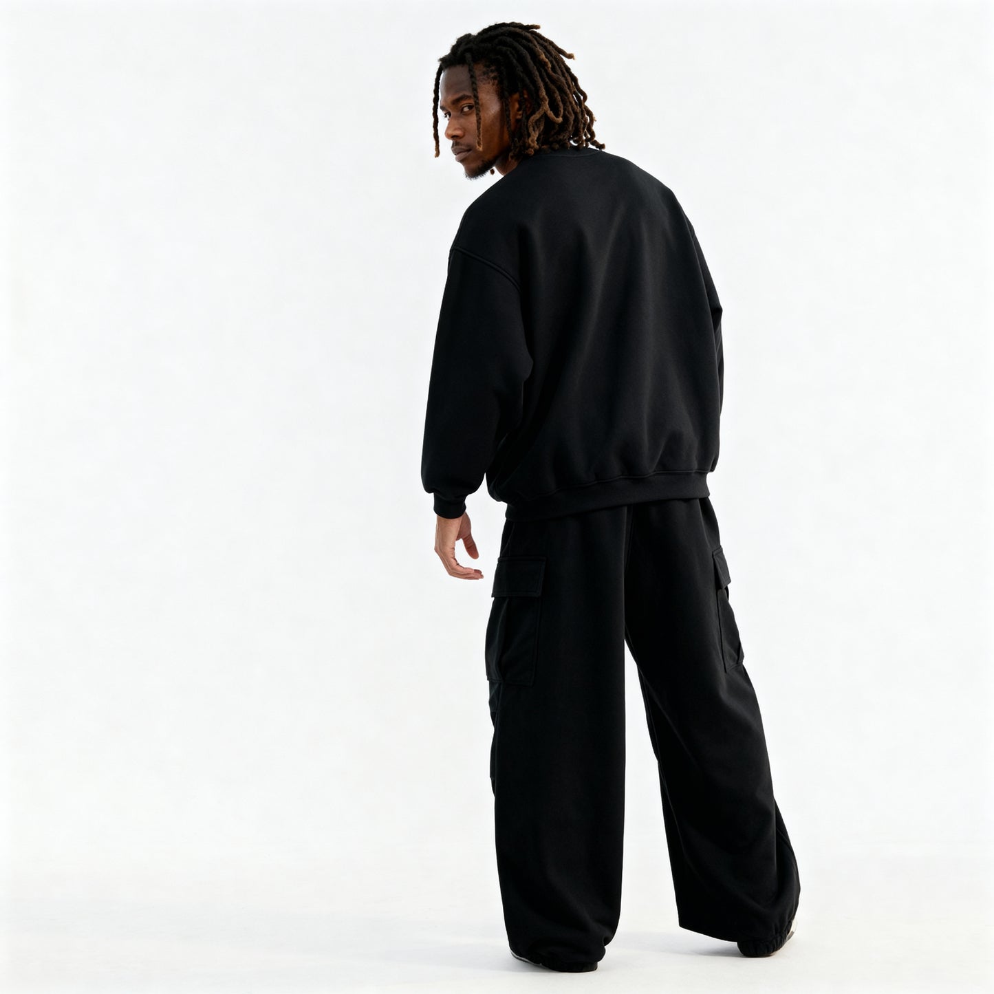 Person wearing a black tracksuit on a white background