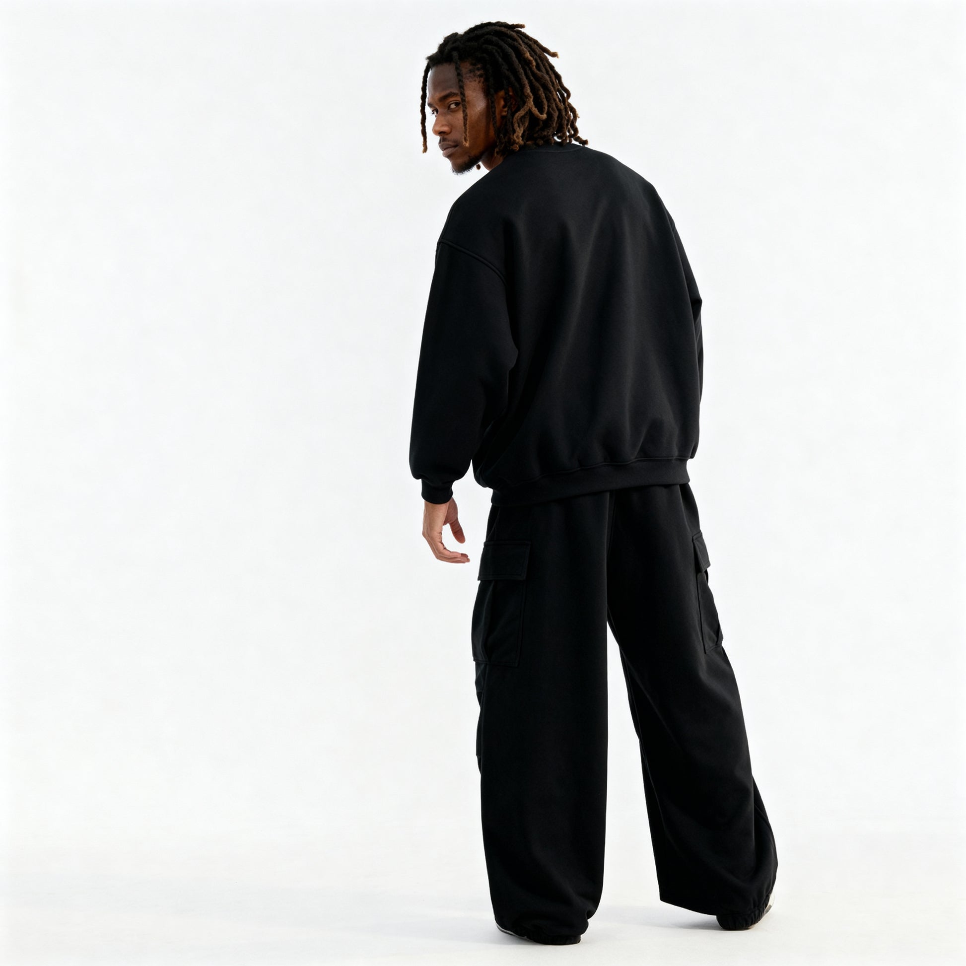 Person wearing a black tracksuit on a white background