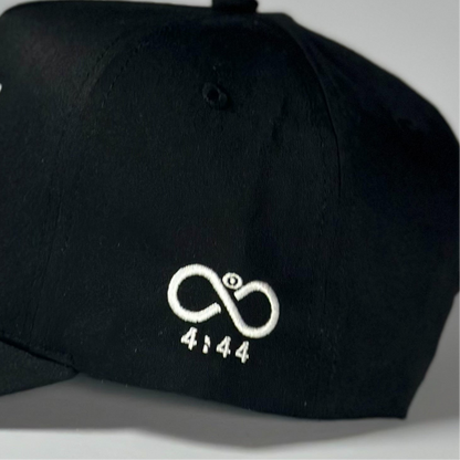 Black cap with a white logo and text on a gray background
