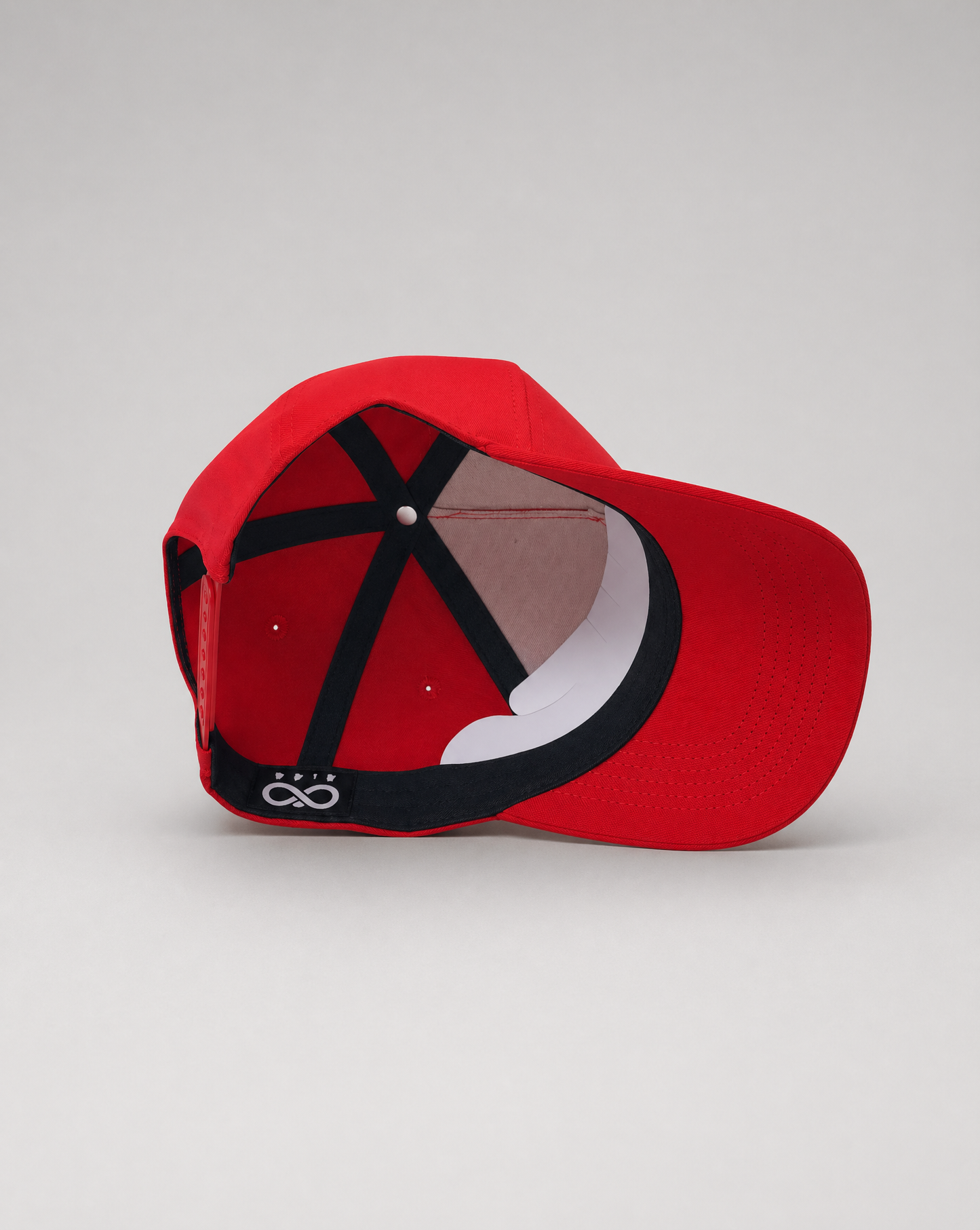 inside of Red eye of horus baseball cap with a black and white design on a white background