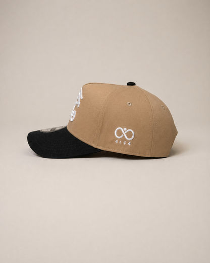 Two-tone cap with beige front and black back on a beige background