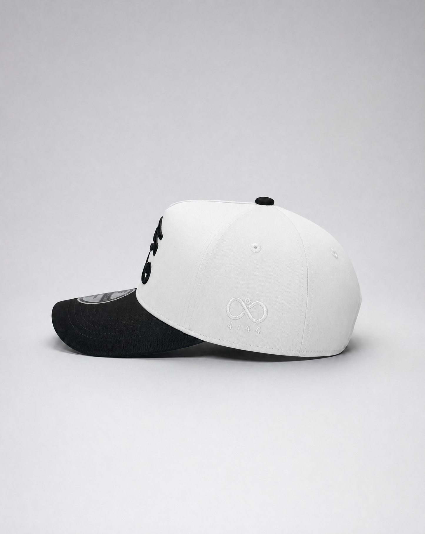 Two baseball caps, one black and one white with a logo, on a light gray background.