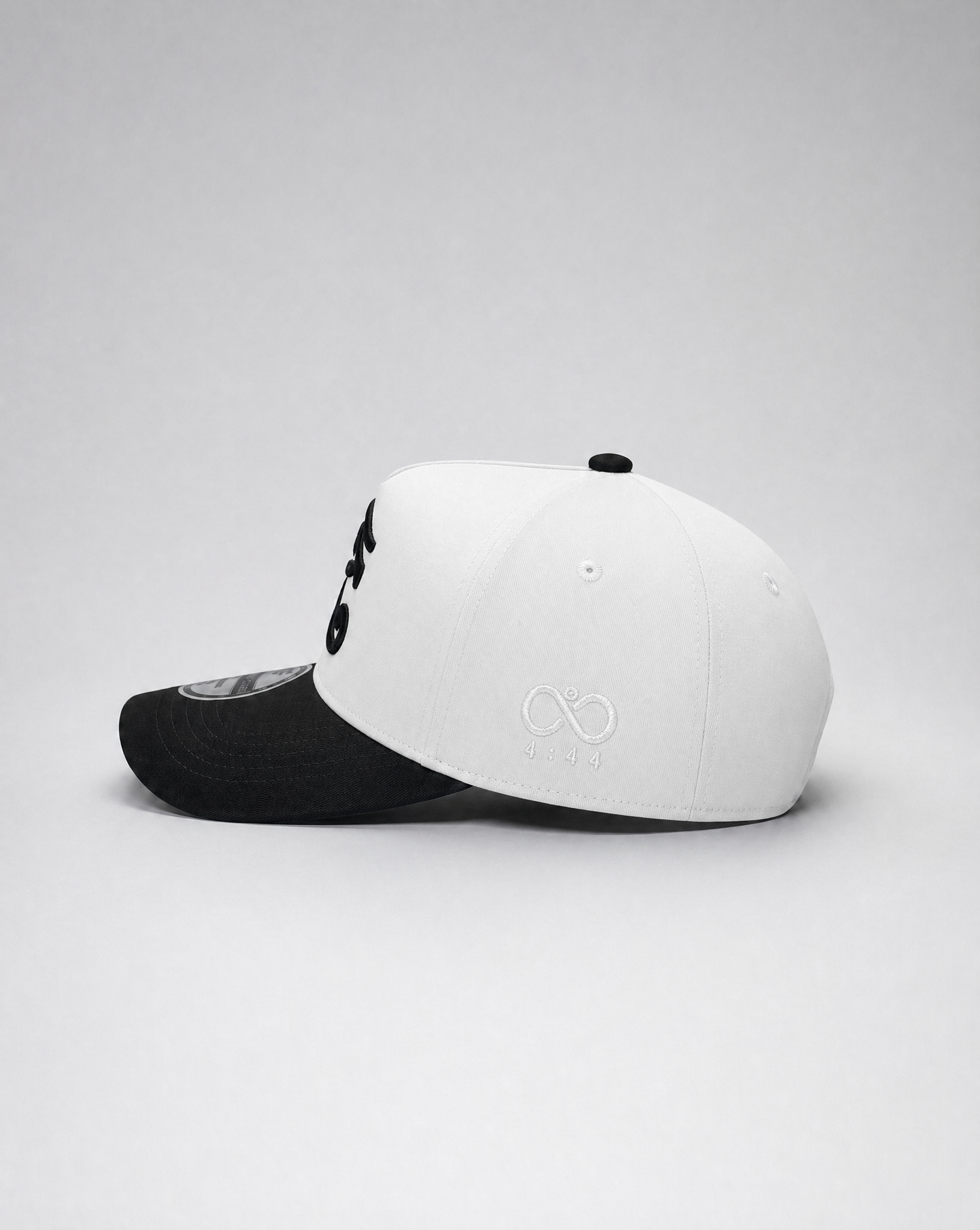 Two baseball caps, one black and one white with a logo, on a light gray background.