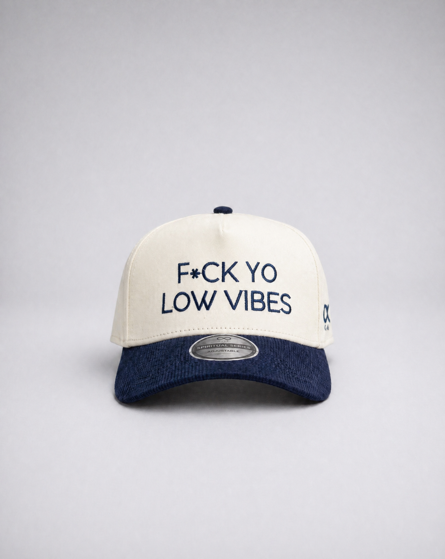 White and navy suded cap with text on a gray background