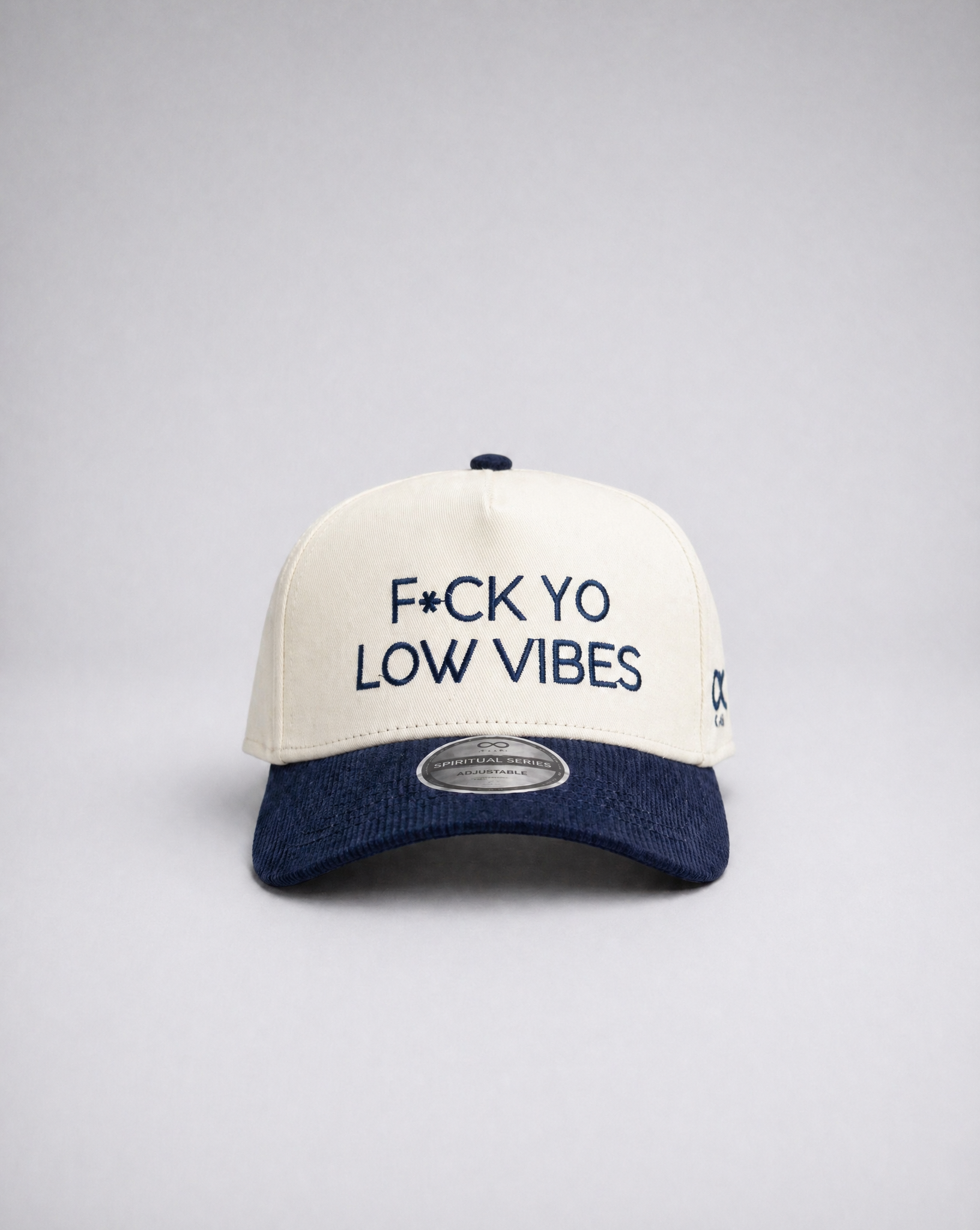 White and navy suded cap with text on a gray background