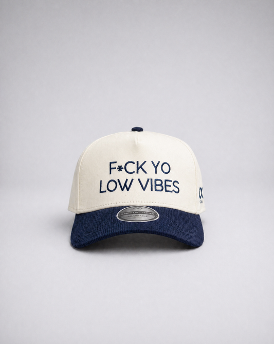 White and navy suded cap with text on a gray background